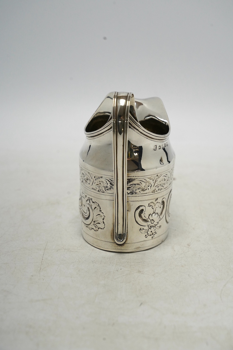 A George III silver cream jug, with later decoration, Robert & David Hennell, London, 1796, 10.4cm, 3.5oz. Condition - poor to fair